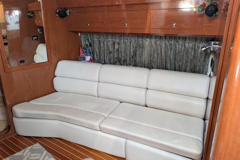 Slide: The Image of Luxurious interior of 2005 Regal Commodore 3560 IO with plush white seating and wooden cabinetry. - 8