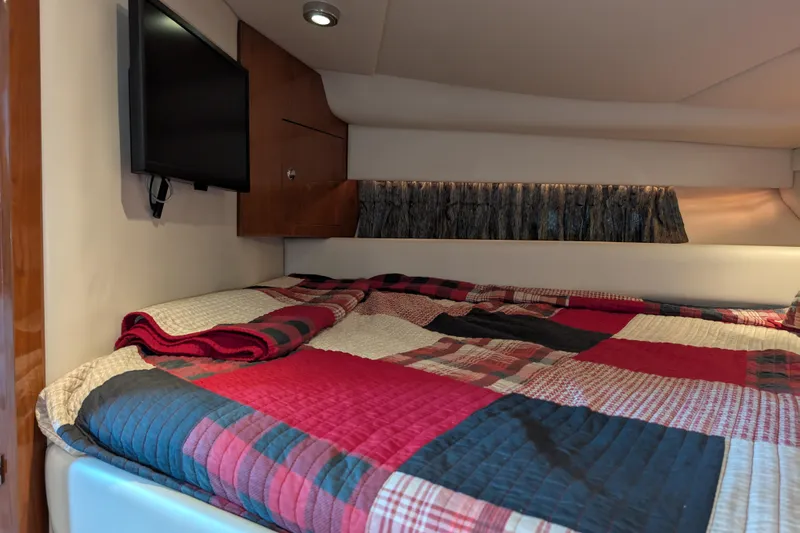 Slide: The Image of Interior cabin of 2005 Regal Commodore 3560 IO with cozy bed and TV. - 10