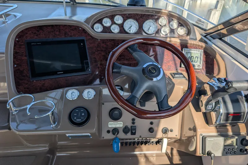 Slide: The Image of 2005 Regal Commodore 3560 IO boat dashboard with steering wheel, gauges, and controls. - 18