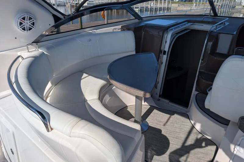 Slide: The Image of 2005 Regal Commodore 3560 IO yacht interior with white seating and triangular table. - 23