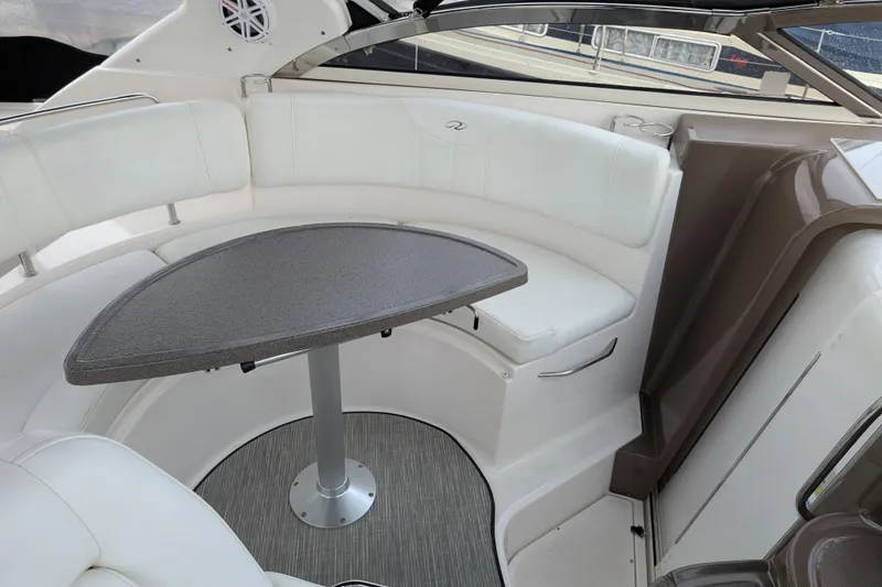 Slide: The Image of Interior of 2005 Regal Commodore 3560 IO boat with white seating and table. - 19