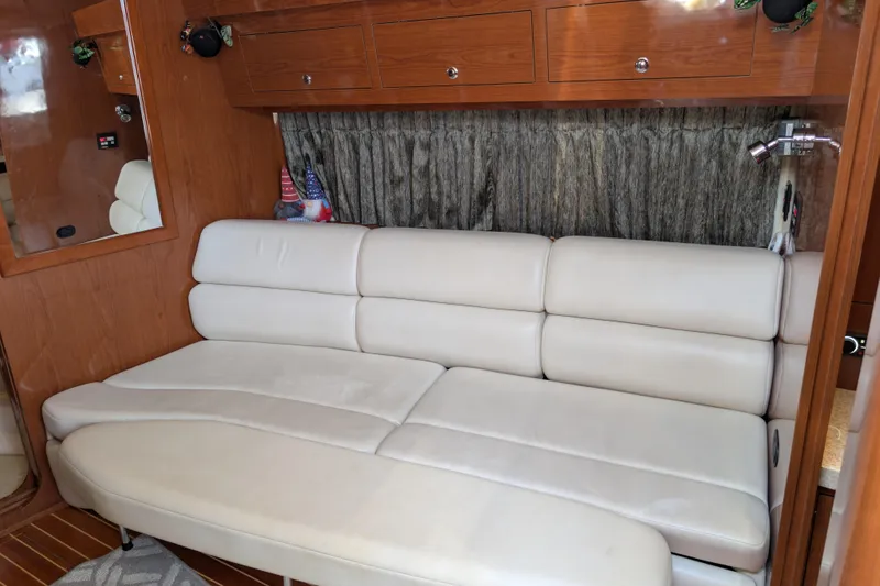 Slide: The Image of Interior of 2005 Regal Commodore 3560 IO with beige leather seating and wooden cabinetry. - 7