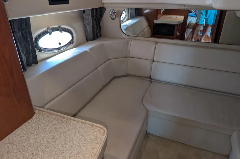 Slide: The Image of Interior of 2005 Regal Commodore 3560 IO yacht with beige seating and porthole window. - 5