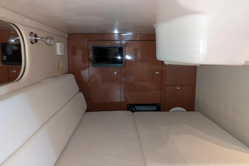 Slide: The Image of Interior cabin of 2005 Regal Commodore 3560 IO with beige seating and wooden cabinetry. - 6