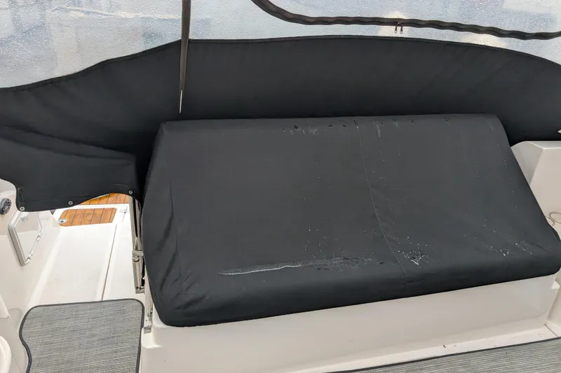 Slide: The Image of Black cushioned seating on a 2005 Regal Commodore 3560 IO boat. - 21
