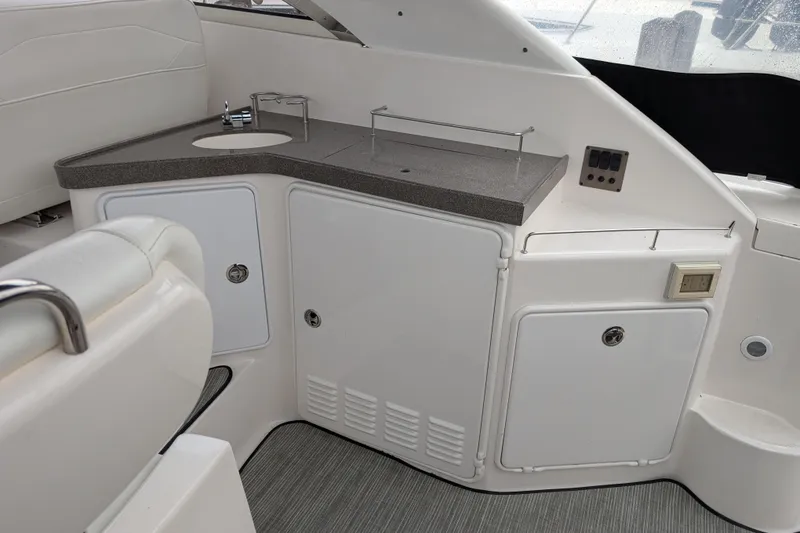 Slide: The Image of 2005 Regal Commodore 3560 IO boat interior with sink and storage cabinets. - 20