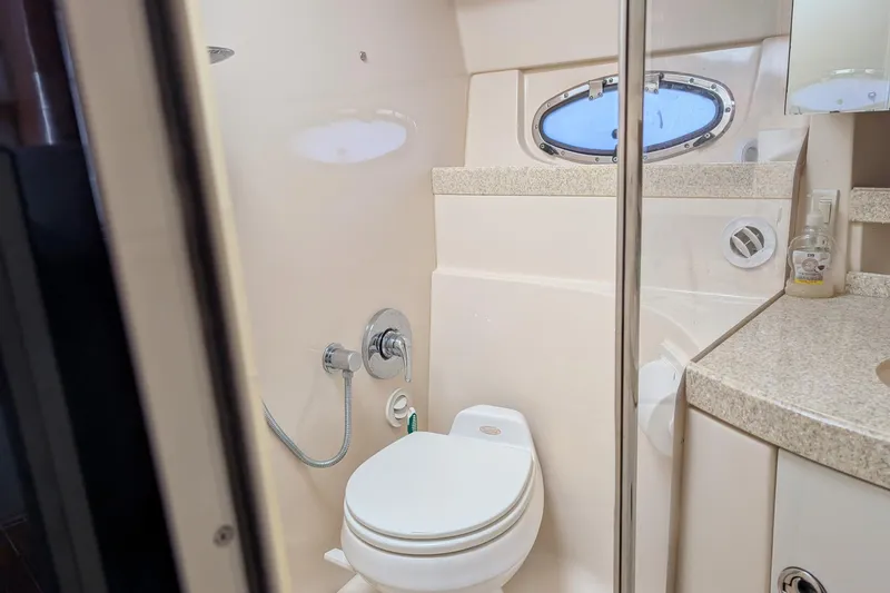 Slide: The Image of Bathroom interior of 2005 Regal Commodore 3560 IO yacht with porthole window. - 16
