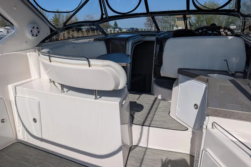 Slide: The Image of Interior of 2005 Regal Commodore 3560 IO boat, featuring seating and helm area. - 24