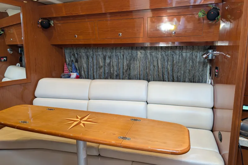 Slide: The Image of Luxurious interior of 2005 Regal Commodore 3560 IO yacht with elegant seating and wooden table. - 9