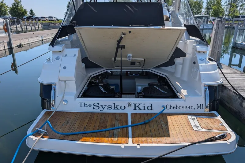 Slide: The Image of 2005 Regal Commodore 3560 IO boat docked, engine compartment open, named "The Sysko Kid," Cheboygan, MI. - 26