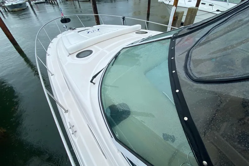 Slide: The Image of 2004 Sea Ray 340 Sundancer boat docked in rainy marina. - 8