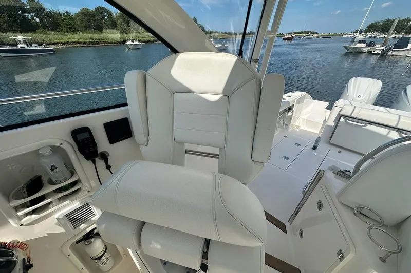 Slide: The Image of Interior of 2022 Pursuit OS 325 Offshore boat with helm seat and water view. - 19