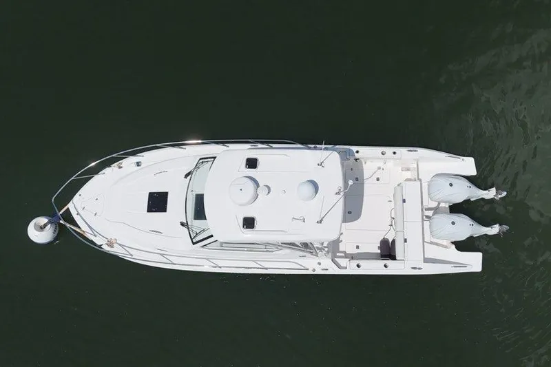 Slide: The Image of Aerial view of 2022 Pursuit OS 325 Offshore boat on calm water. - 9