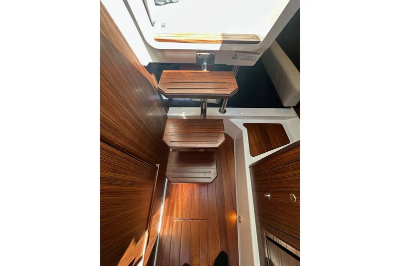 Slide: The Image of Interior of 2022 Pursuit OS 325 Offshore boat with wooden steps and flooring. - 31