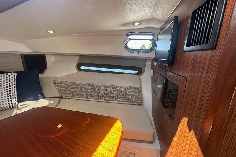 Slide: The Image of Interior of 2022 Pursuit OS 325 Offshore boat with cozy seating and wooden accents. - 24