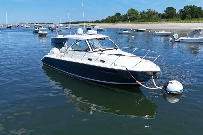Slide: The Image of 2022 Pursuit OS 325 Offshore boat moored in a serene harbor setting. - 3