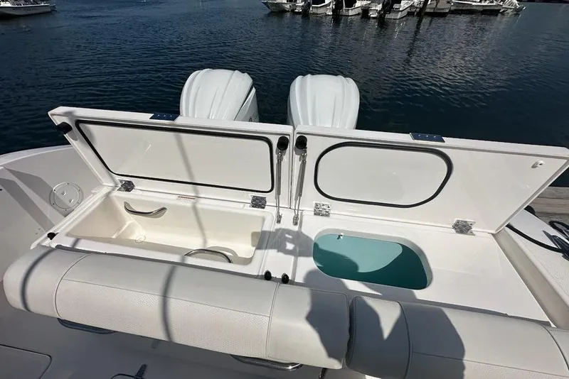 Slide: The Image of 2022 Pursuit OS 325 Offshore boat with open storage compartments at the dock. - 42