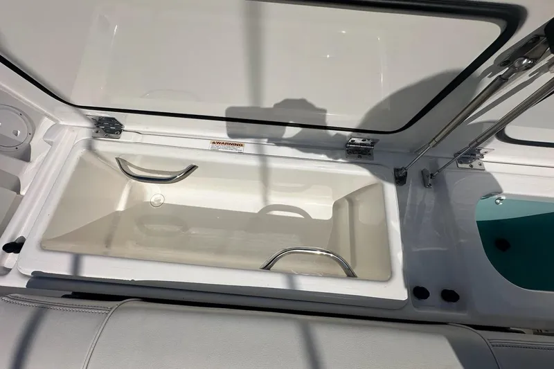 Slide: The Image of Open storage compartment on 2022 Pursuit OS 325 Offshore boat. - 44