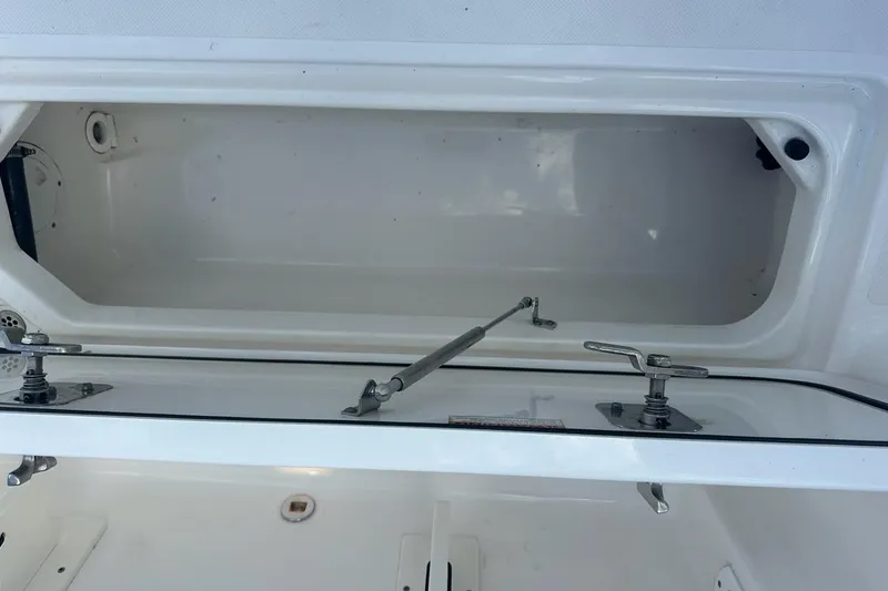 Slide: The Image of Storage compartment of 2022 Pursuit OS 325 Offshore boat, featuring secure latches and spacious interior. - 48