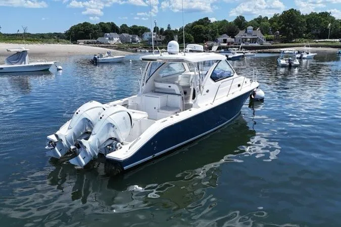 Slide: The Image of 2022 Pursuit OS 325 Offshore boat docked in a scenic harbor. - 5