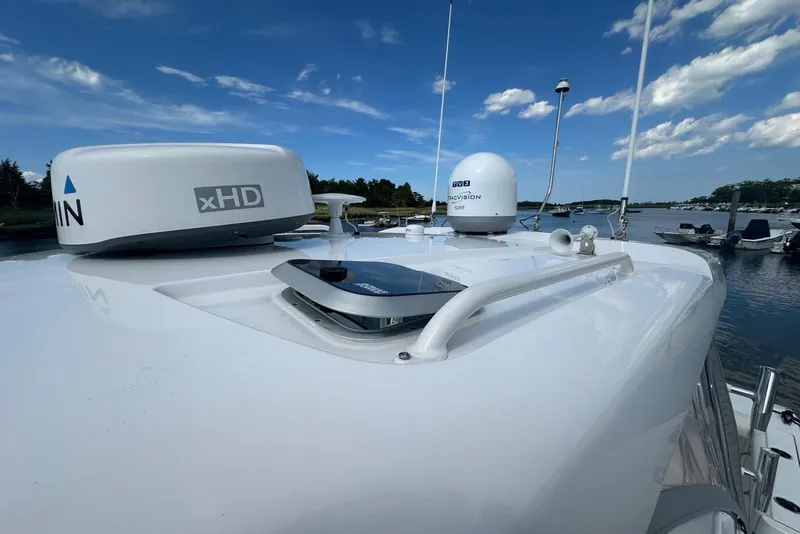 Slide: The Image of 2022 Pursuit OS 325 Offshore boat with radar and navigation equipment on deck. - 52