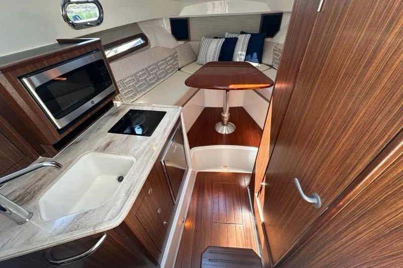 Slide: The Image of Luxurious interior of 2022 Pursuit OS 325 Offshore boat with kitchen and seating area. - 21