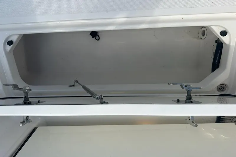 Slide: The Image of Open storage compartment on a 2022 Pursuit OS 325 Offshore boat. - 49