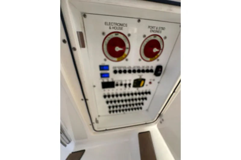 Slide: The Image of Control panel of 2022 Pursuit OS 325 Offshore boat with switches and dials. - 39