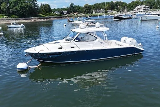 Slide: The Image of 2022 Pursuit OS 325 Offshore boat docked in a scenic marina. - 4