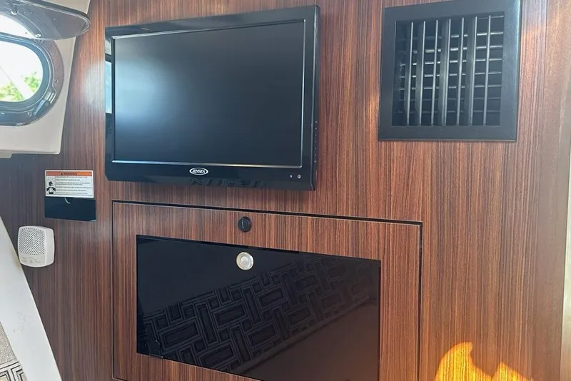 Slide: The Image of Interior of 2022 Pursuit OS 325 Offshore with TV and wood paneling. - 26