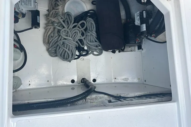 Slide: The Image of Storage compartment of 2022 Pursuit OS 325 Offshore boat with ropes and equipment. - 51