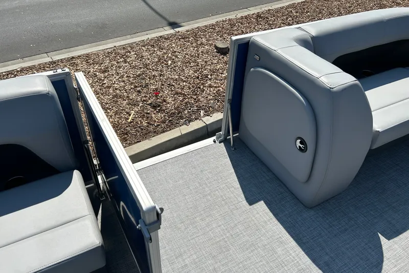 Slide: The Image of 2026 Sun Tracker Party Barge 18 DLX interior with gray seating and open gate. - 13