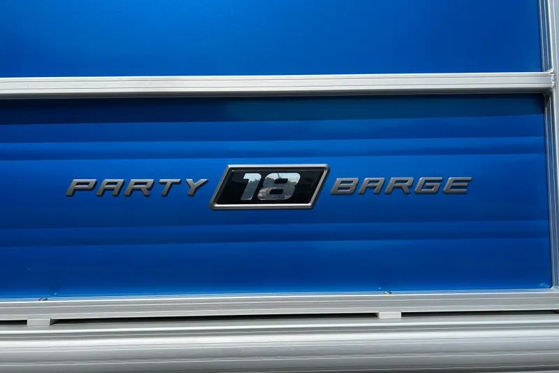 Slide: The Image of 2026 Sun Tracker Party Barge 18 DLX logo on blue background. - 24