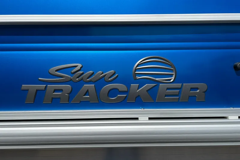 Slide: The Image of 2026 Sun Tracker Party Barge 18 DLX logo on blue background. - 25