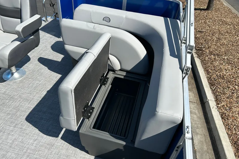 Slide: The Image of 2026 Sun Tracker Party Barge 18 DLX with open storage compartment and seating. - 18