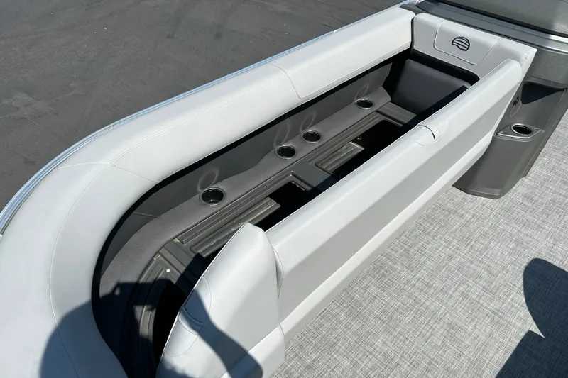 Slide: The Image of 2026 Sun Tracker Party Barge 18 DLX interior seating with cup holders, gray upholstery. - 16