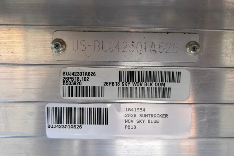Slide: The Image of 2026 Sun Tracker Party Barge 18 DLX identification tags with serial numbers and barcodes. - 94