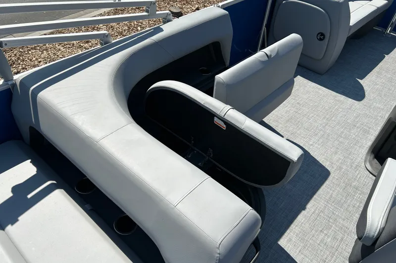 Slide: The Image of 2026 Sun Tracker Party Barge 18 DLX interior with gray seating and storage compartments. - 19