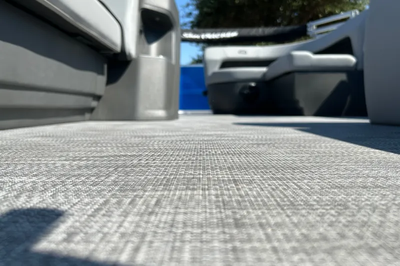 Slide: The Image of 2026 Sun Tracker Party Barge 18 DLX interior flooring, showcasing textured design and seating. - 23