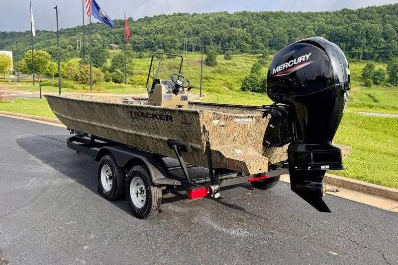 Slide: The Image of 2026 Tracker Grizzly 2072 CC boat with Mercury engine on trailer, parked outdoors. - 7