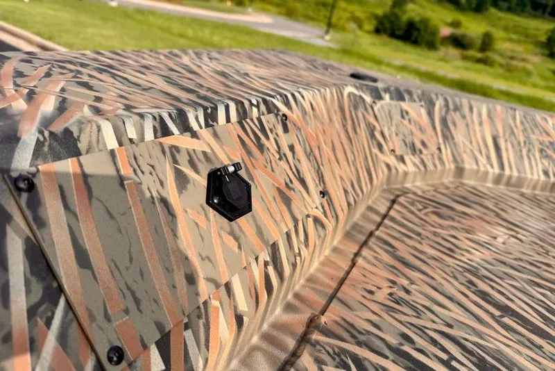 Slide: The Image of 2026 Tracker Grizzly 2072 CC boat with camouflage pattern in a scenic outdoor setting. - 8