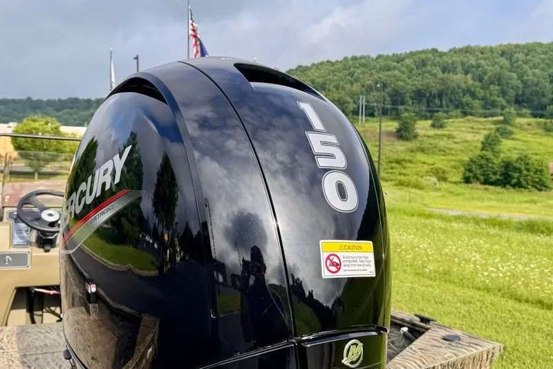Slide: The Image of Mercury 150 outboard motor on 2026 Tracker Grizzly 2072 CC, scenic background. - 6