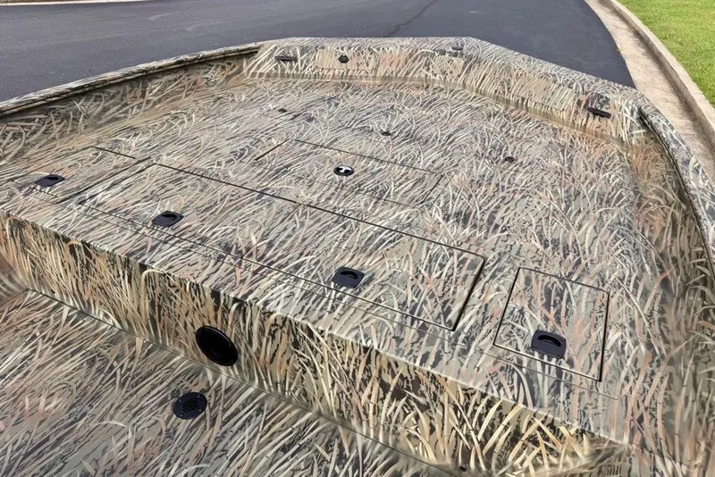 Slide: The Image of 2026 Tracker Grizzly 2072 CC boat with camouflage design on a paved road. - 52