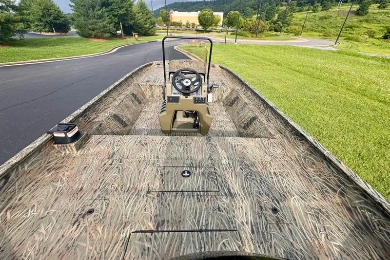 Slide: The Image of 2026 Tracker Grizzly 2072 CC boat with camouflage design on a paved road. - 10