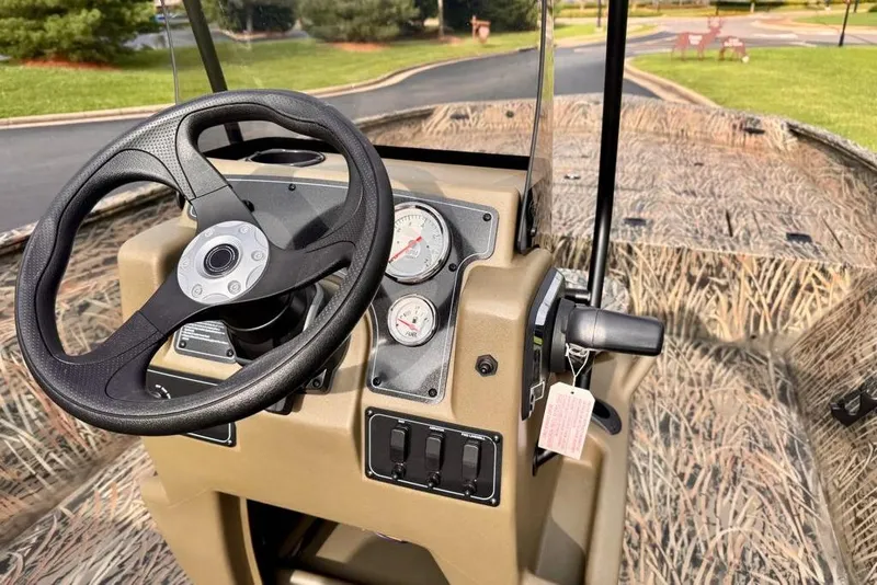 Slide: The Image of 2026 Tracker Grizzly 2072 CC boat dashboard with steering wheel and gauges. - 12