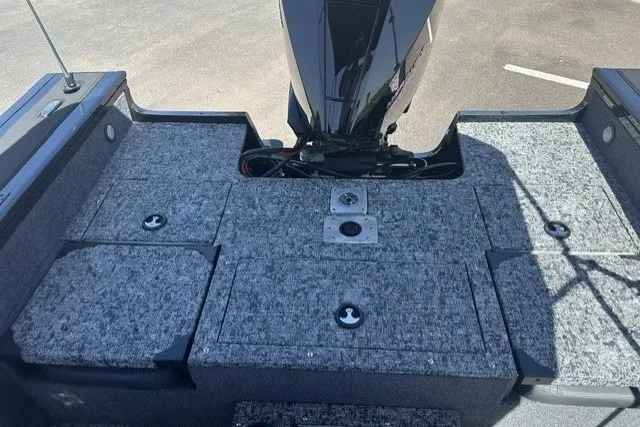 Slide: The Image of 2026 Tracker Targa V-19 Combo boat interior with carpeted deck and motor. - 16