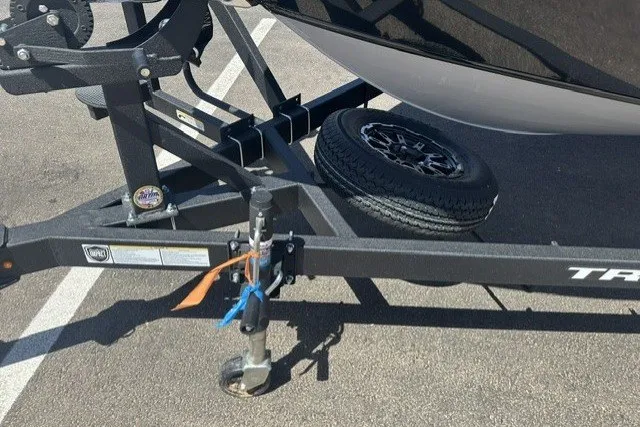 Slide: The Image of Trailer hitch of a 2026 Tracker Targa V-19 Combo with spare tire in parking lot. - 20