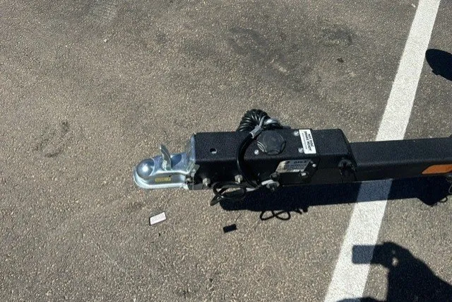 Slide: The Image of Trailer hitch of 2026 Tracker Targa V-19 Combo on asphalt parking lot. - 19