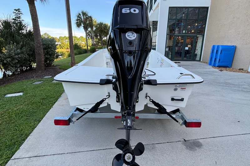 Slide: The Image of 2026 Mako Pro Skiff 15 CC boat with 60 HP engine on trailer. - 3