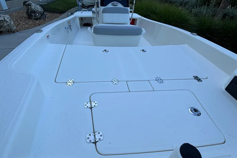 Slide: The Image of 2026 Mako Pro Skiff 15 CC boat deck with storage compartments and seating. - 6